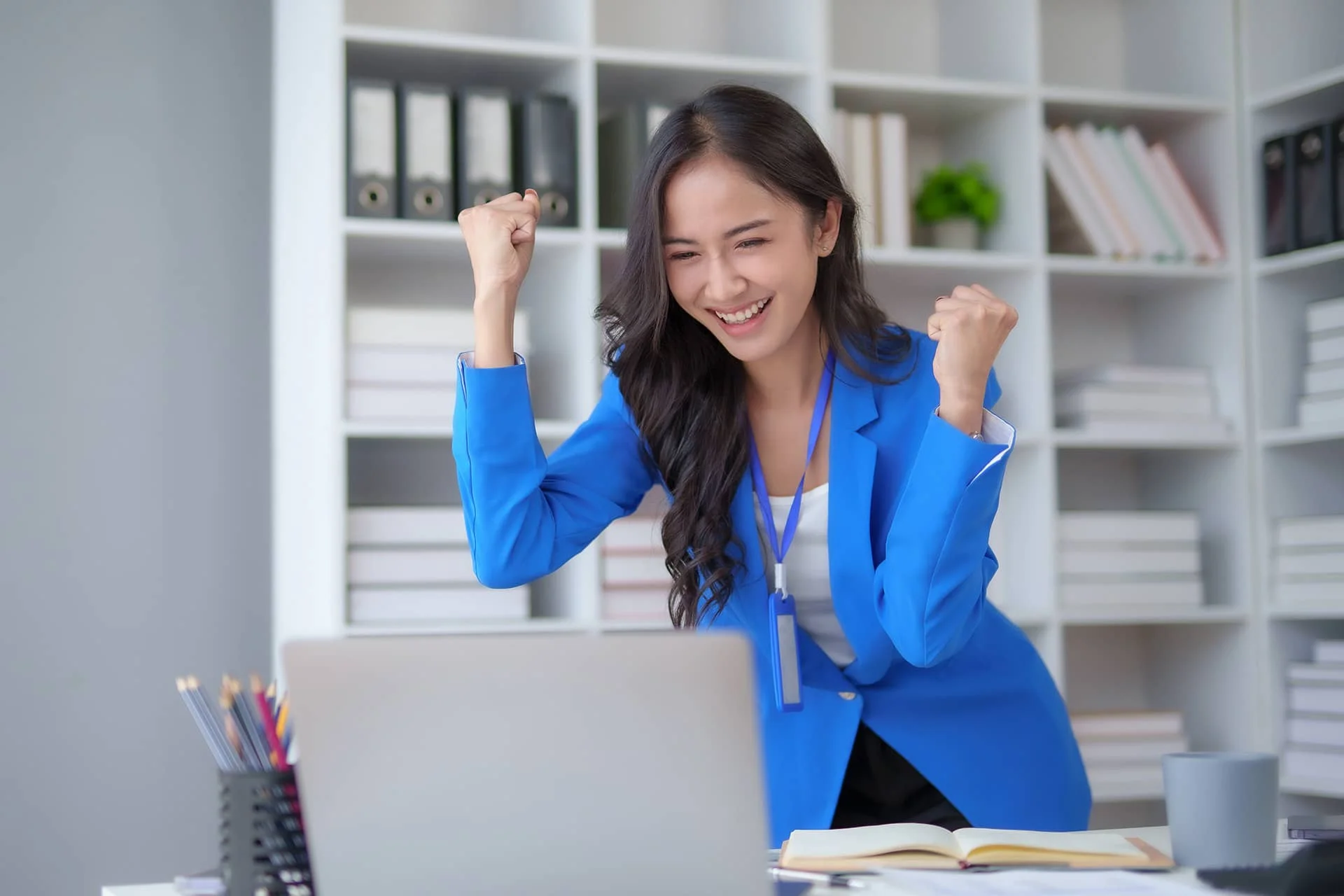 happy-asian-businesswoman-raising-hands-with-victo-8R4UKVZ.jpg